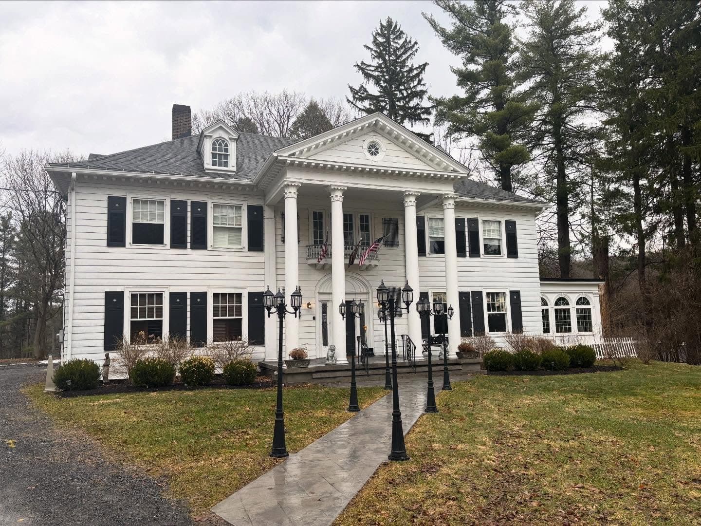 Instagram post: A large white colonial-style house with tall columns