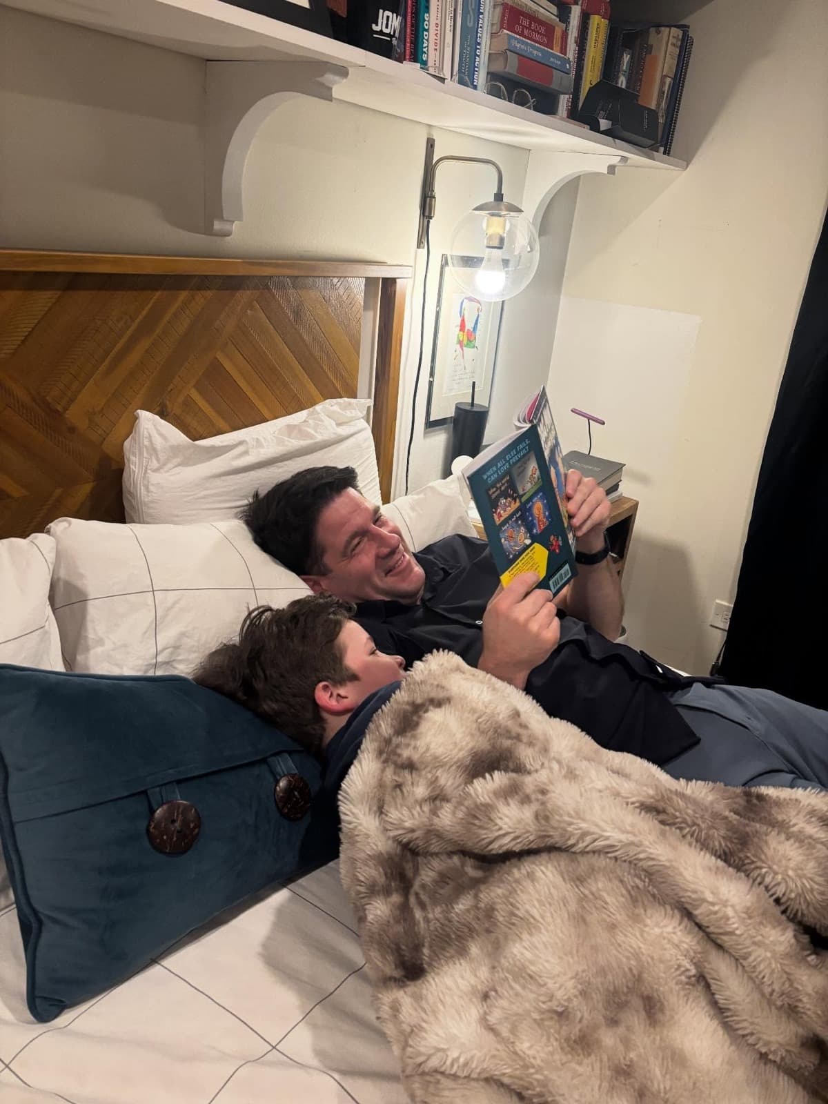 Instagram post: Two of Liesl's family members reading a book together in bed