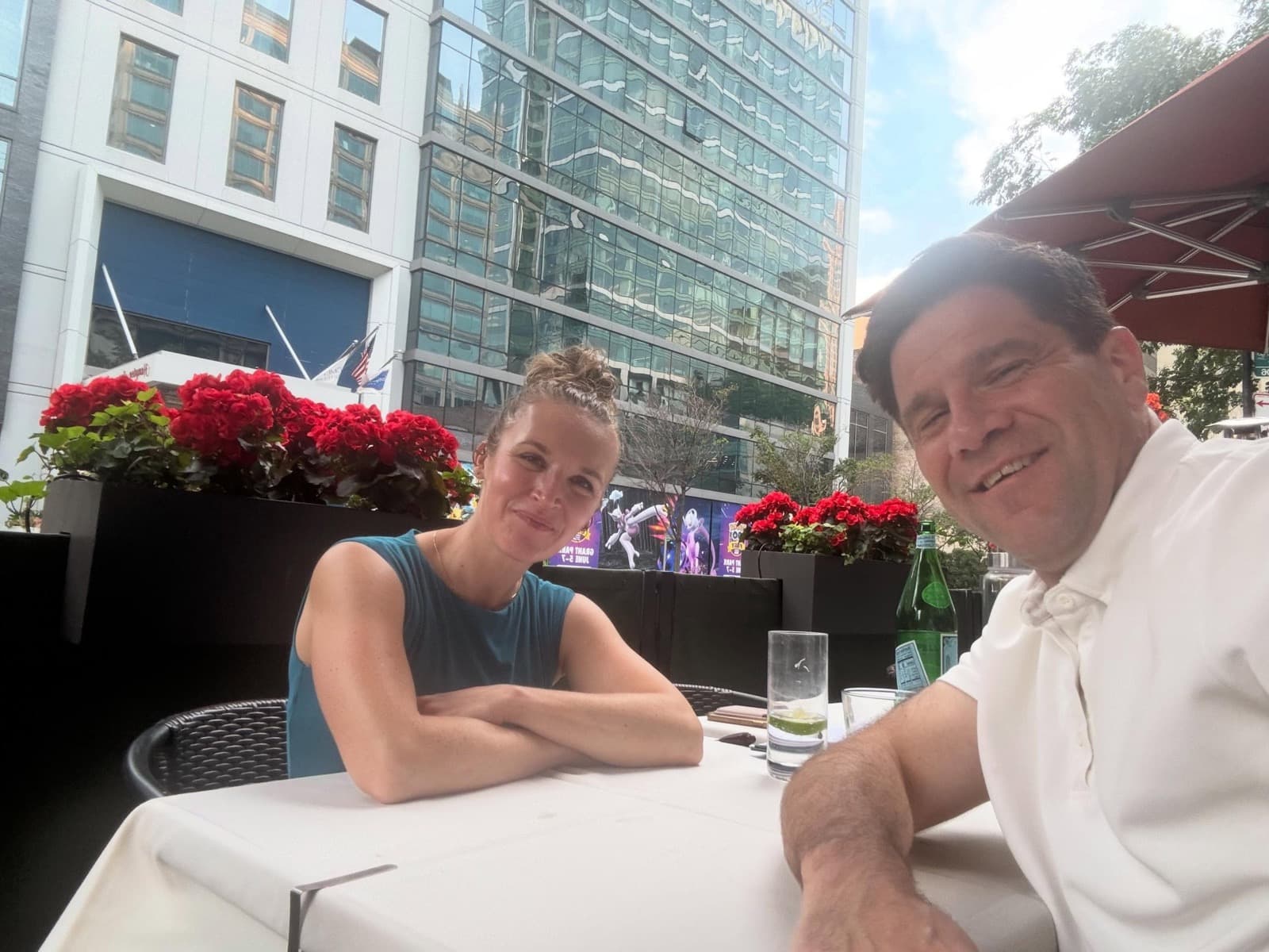 Instagram post: Liesl smiling with a friend at an outdoor restaurant table in the city