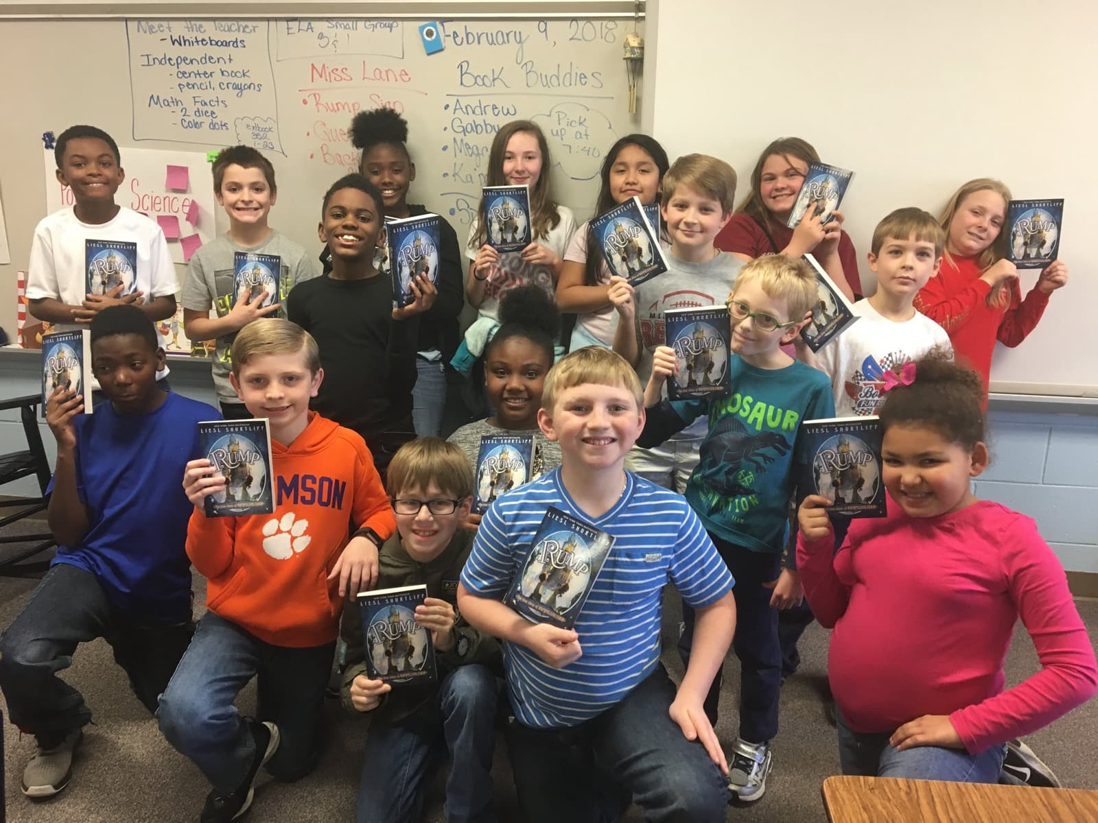 A class holding up their copies of RUMP after a virtual visit