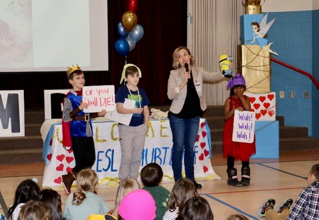 Liesl on stage with students dressed as fairytale characters