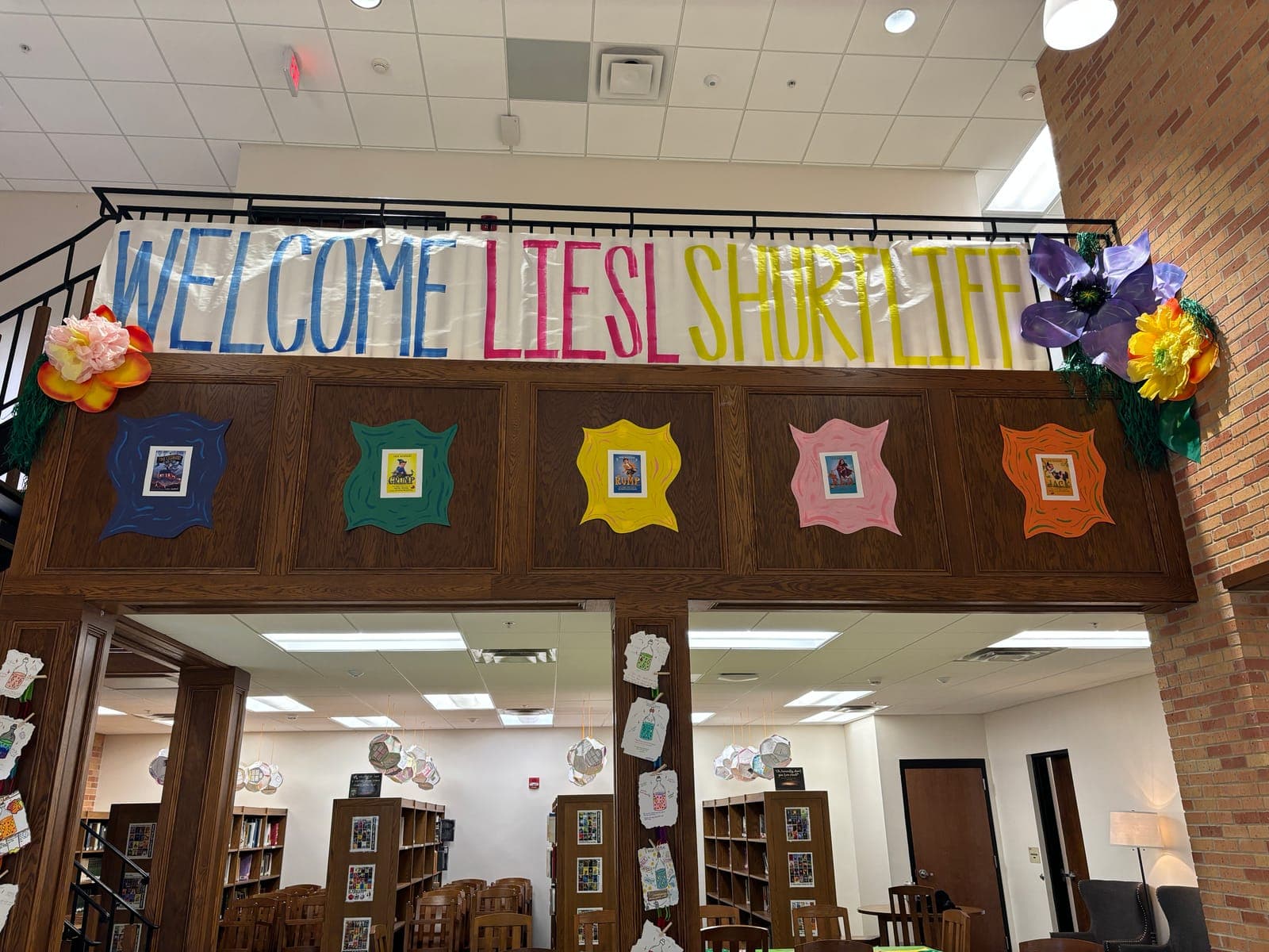 A "Welcome Liesl Shurtliff" banner in a school library