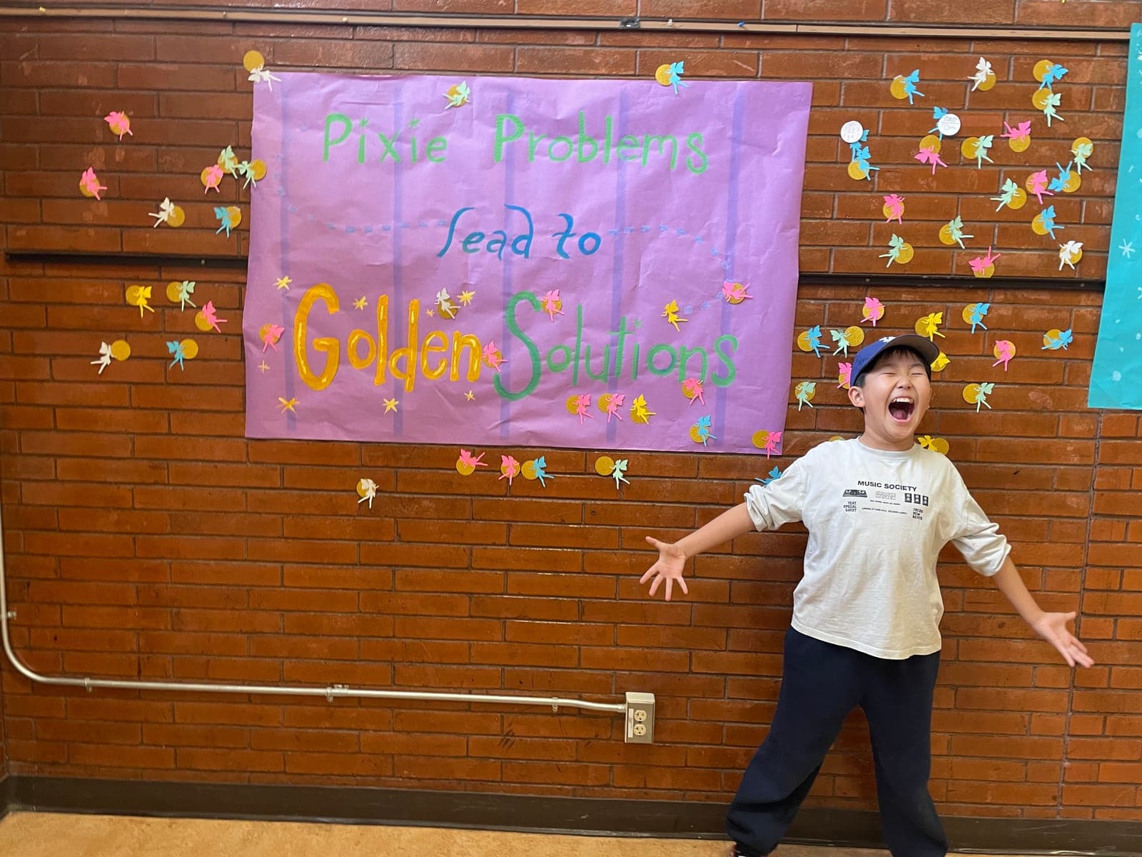 An excited student in front of a school-visit welcome banner
