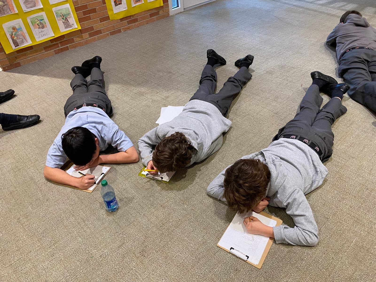Students writing on the floor during a writing workshop